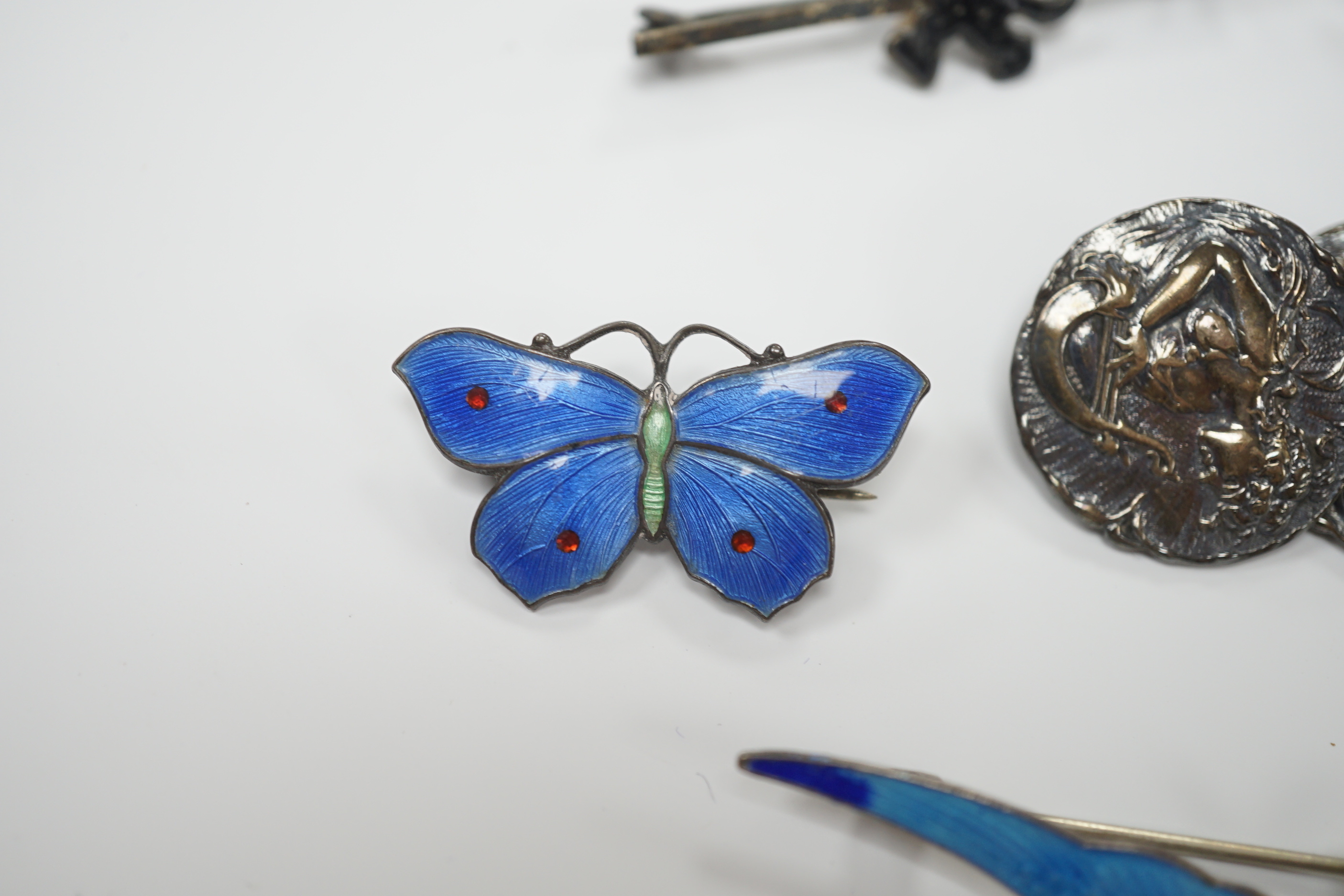 A Norwegian 925S and two colour enamel oval brooch, 28mm, a sterling and three colour enamel butterfly brooch, a white metal (stamped silver) and enamel swallow brooch, a pair of Edwardian Art Nouveau silver buttons and